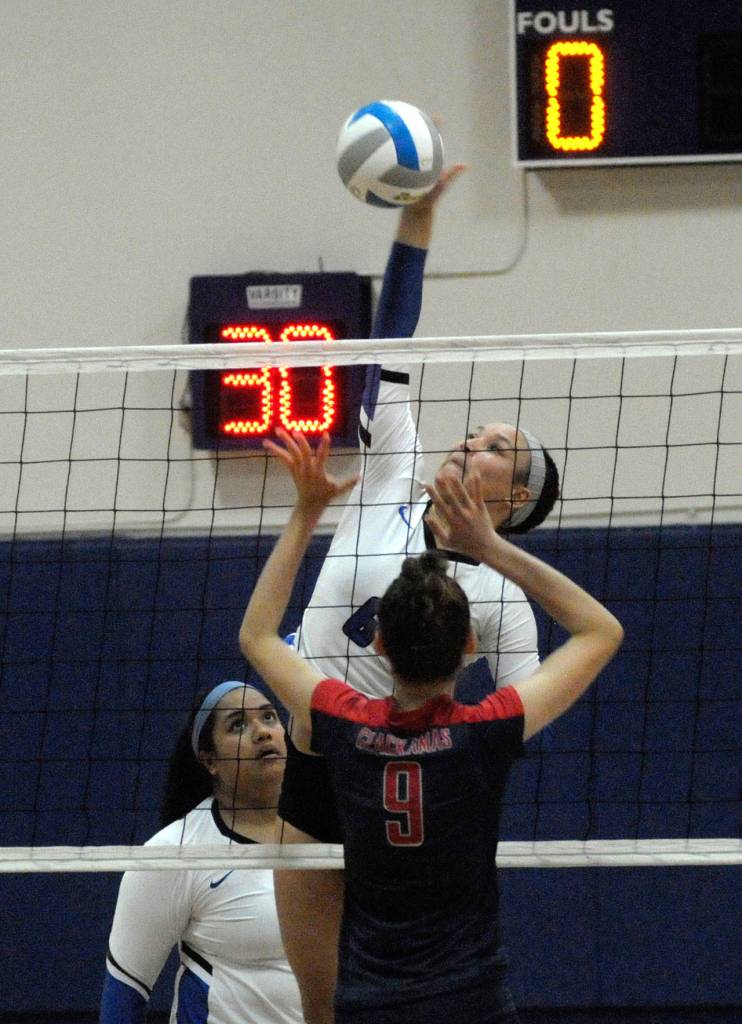 Grays Harbors Naomi Harris, background, gets a shot over a block attempt in a match against Clackamas on Monday night at the Choker Gym. (Hasani Grayson | The Daily World)