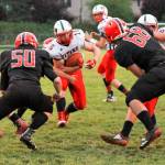 Pe Ell-Willapa Valleys Max Smith carries the ball during the Titans 28-24 victory over Raymond on Friday at Raymond High School. (Photo by Larry Bale)
