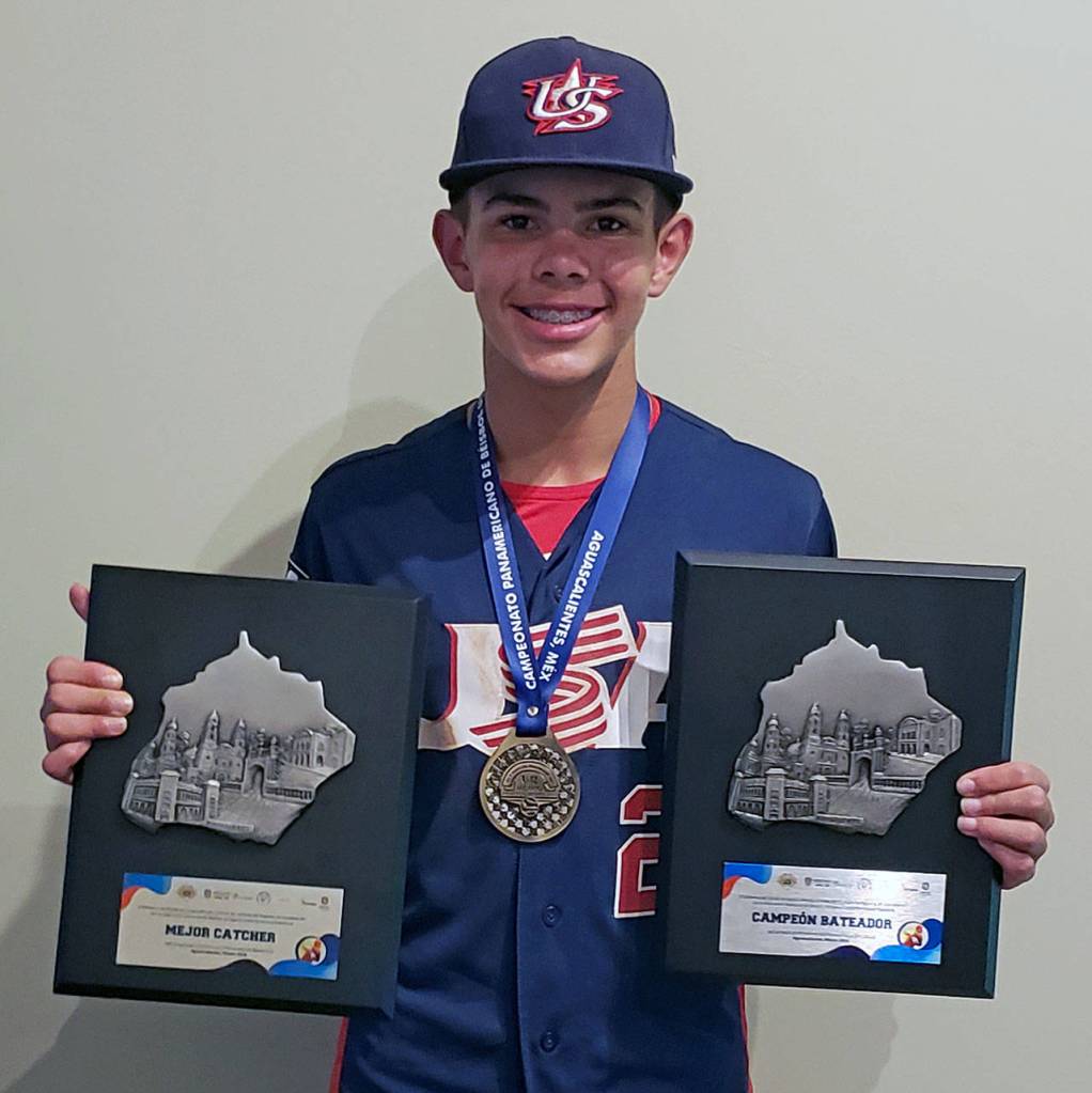 Kai Halstead poses with his gold medal, the top catcher and top batter honors he was awarded at the 2018 COPABE Pan Am Championships in early September. (Ryan Sparks | The Daily World)