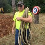 (Photo by Jeff Cook) Jim Welch, part of the Saginaw Days committee, carries the rope to the pond in preparation for the Tug-of-War.