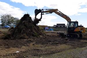 Louis Krauss | The Daily World                                An Aberdeen Public Works employee uses an excavator to move dirt near homeless camps along the Chehalis River.