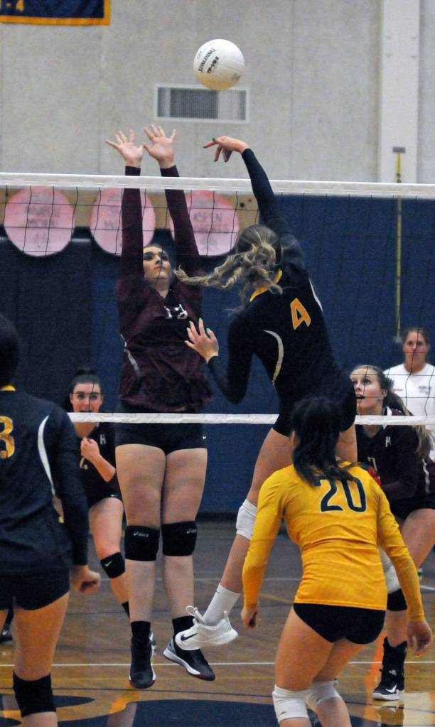 Aberdeens Kennedy Pruett (4) goes for a kill attempt against Hoquiams Rylee Vonhof during a game on Tuesday at Aberdeen High School. (Ryan Sparks | The Daily World)