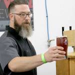 O-Town Brewing of Olympia was on-hand at 2017s Catch Montesano Fish and Brew Fest downtown. Brewer Jason Stenzel offered a freshly poured beer to an attendee inside Whitneys detail shop.