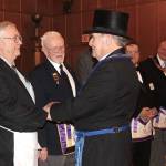 As master of Wynooche 43, Free and Accepted Masons of Washington, Walt Twidwell is the only member allowed to wear a hat inside the lodge at Montesano. After being installed as master last Christmas, Twidwell thanked North River neighbor Jim Banas, left. At center is Sherman Richmond of Ocean Park, past master of the Ilwaco Masons lodge. (Photo by Patrick Webb)