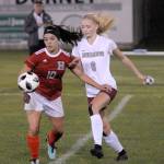 Hoquiams Kylie Bell, left, and Montesanos Anna Ayers fight for a loose ball at Olympic Stadium on Tuesday. (Hasani Grayson | The Daily World)