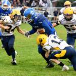 Taitum Brumfield carries the football as Aberdeens Aidan Neeley, left, and Connar Sherman converge on the tackle last Friday in Elma. (Photo by Sue Michalak)