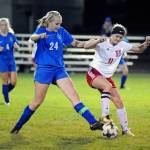 Elmas Molly Johnston and Hoquiams Maya Jump jostle for possession during the Eagles 5-1 victory over the Grizzlies on Thursday at Elma High School. (Ryan Sparks | The Daily World)