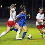 Elmas Jayla Mason, middle, splits Hoquiams Kylee Bagwell and Kylie Bell, right, to score an unassisted goal that gave the Eagles a 2-0 lead in the first half on Thursday in Elma. (Ryan Sparks | The Daily World)