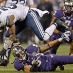 Brigham Young running back Jamaal Williams (21) leaps over Washington linebacker John Timu (10) for extra yardage in the second quarter of the Fight Hunger Bowl at AT&T Park in San Francisco on Friday, Dec. 27, 2013. (Jose Carlos Fajardo/Bay Area News Group/MCT)