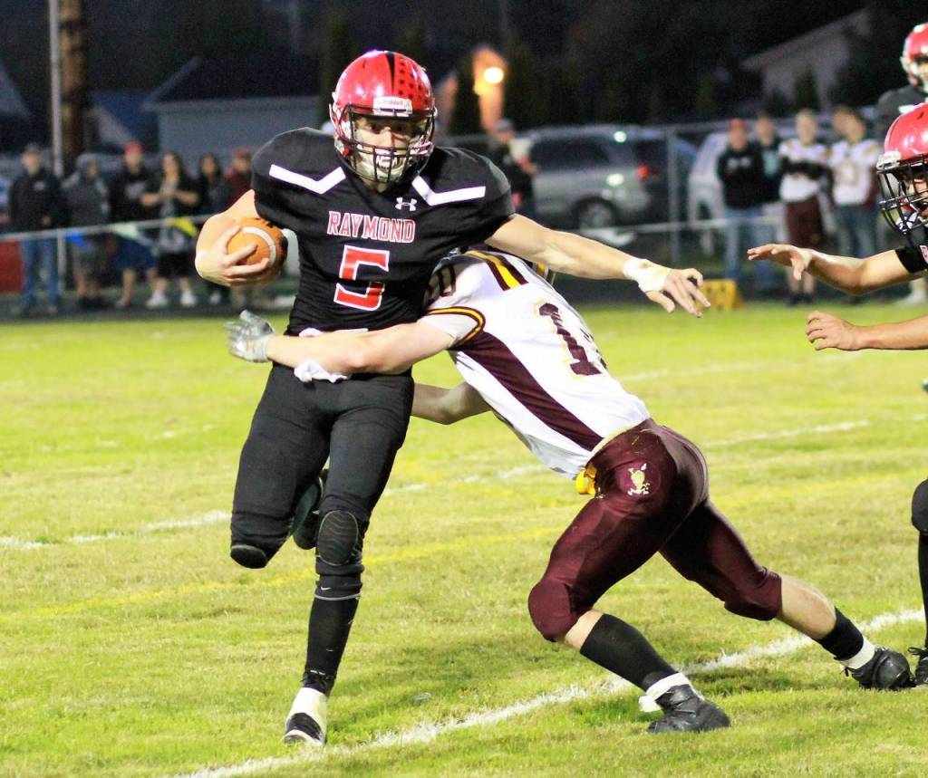 Raymonds Patrick Edwards, left, runs the football during the Seagulls game against South Bend on Friday. (Photo by Larry Bale)
