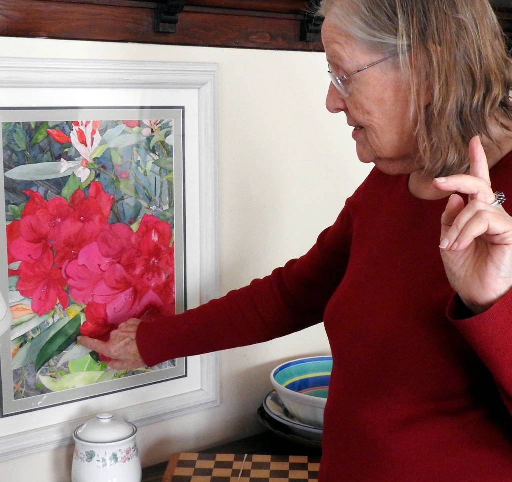 Swanson explains how she used a single green pigment to paint both the light and dark sides of the leaves in this piece, which hangs in her dining room.