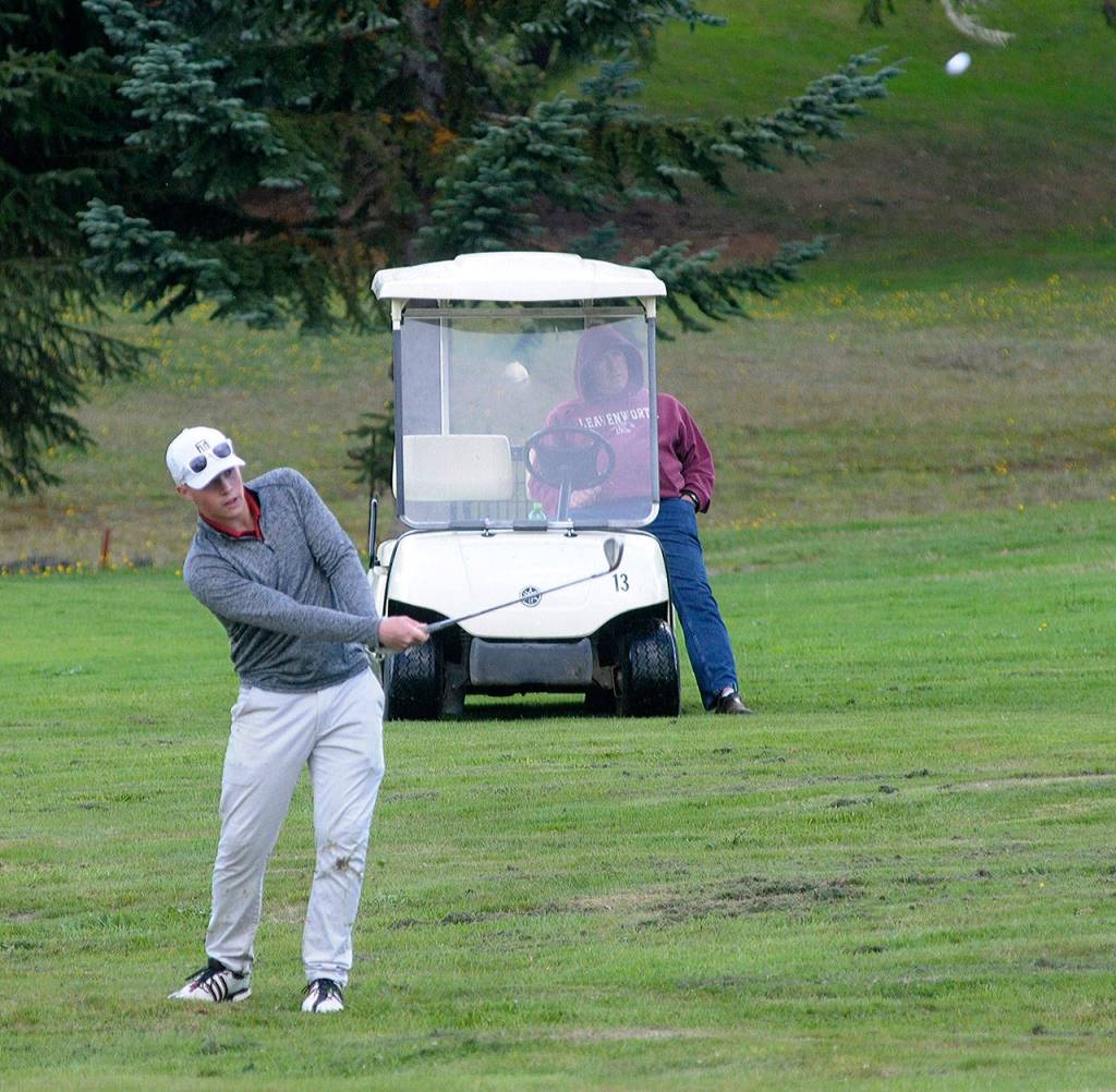 Hoquiams Josh Burgher takes a shot from the fairway on the 10th hole at Highlands Golf Course on Tuesday. Bugher led the Bulldogs with a round of 36.