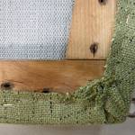 (Photo by Mitchell Chapman) To finish each corner, pull the fabric tight, then twist it under the frame and staple it. This usually results in a cleaner look.