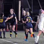 Aberdeens Emmy Walsh (2) is congratulated by Alexie Darst and other teammates after giving her team the lead with a second half goal against Black Hills Thursday night at Stewart Field. Aberdeen eventually lost on penalty kicks 3-2. (Hasani Grayson | The Daily World)