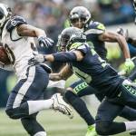 Seattle Seahawks Bradley McDougald jumps to tackle Rams Todd Gurley II as the Seahawks take onthe Rams at CenturyLink Field on Sunday, Oct. 7, 2018 in Seattle. (Rebekah Welch/The Seattle Times/TNS)