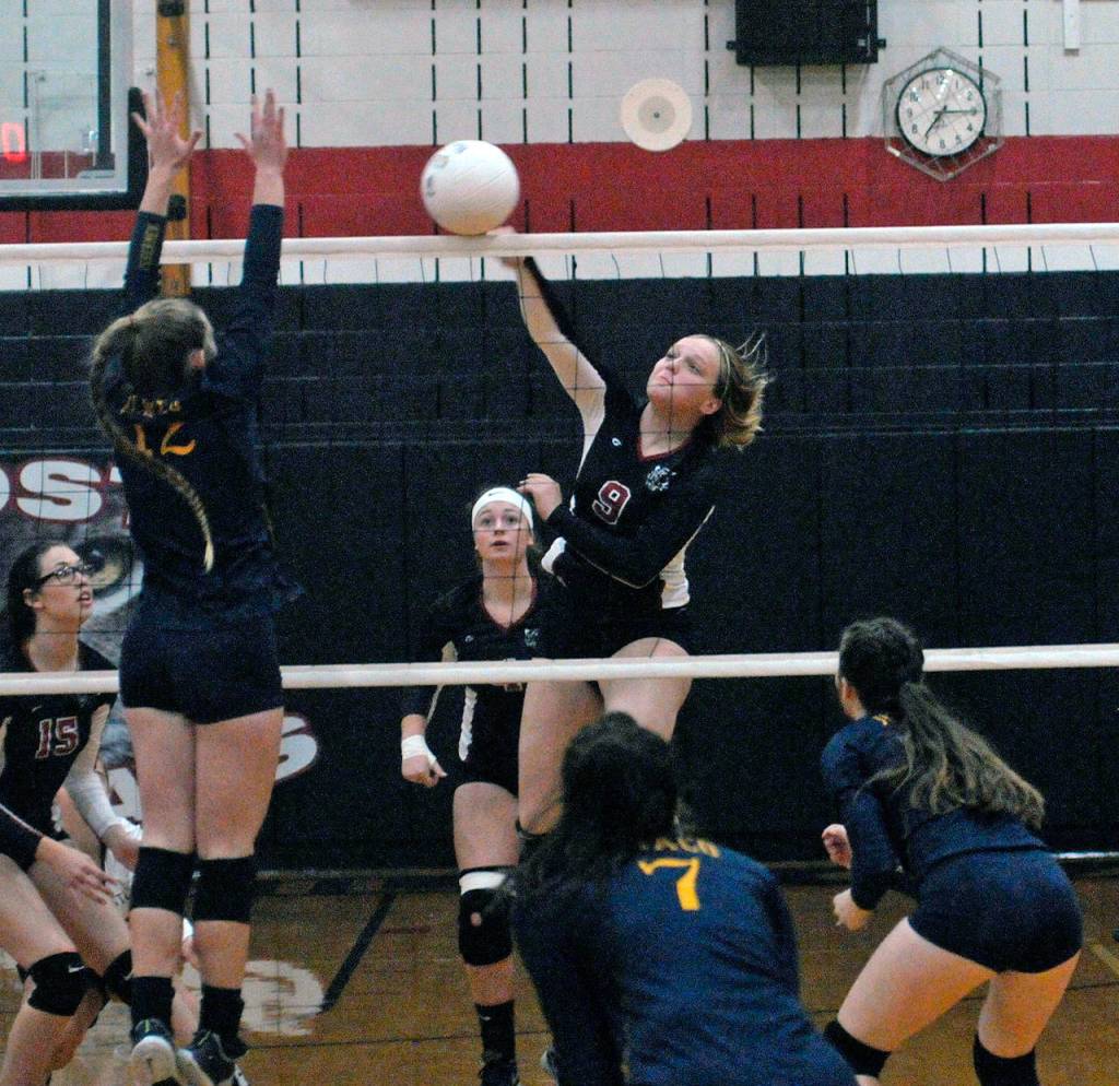 Ocostas Layne Martin gets a kill in match against Ilwaco. Martin led the team with 14 kills in Ocostas 3-0 win over the Fishermen on Tuesday. (Hasani Grayson | The Daily World)