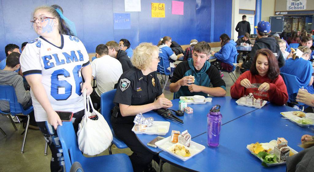 Photos by Michael Lang | The Vidette                                Elma Police Chief Susan Shultz (center) chats with high-schoolers during lunch Thursday, Oct. 4, at Elma High School in Elma. There are opportunities for private conversations with students to encourage them through personal challenges and offering support if needed, she said of the time with students.