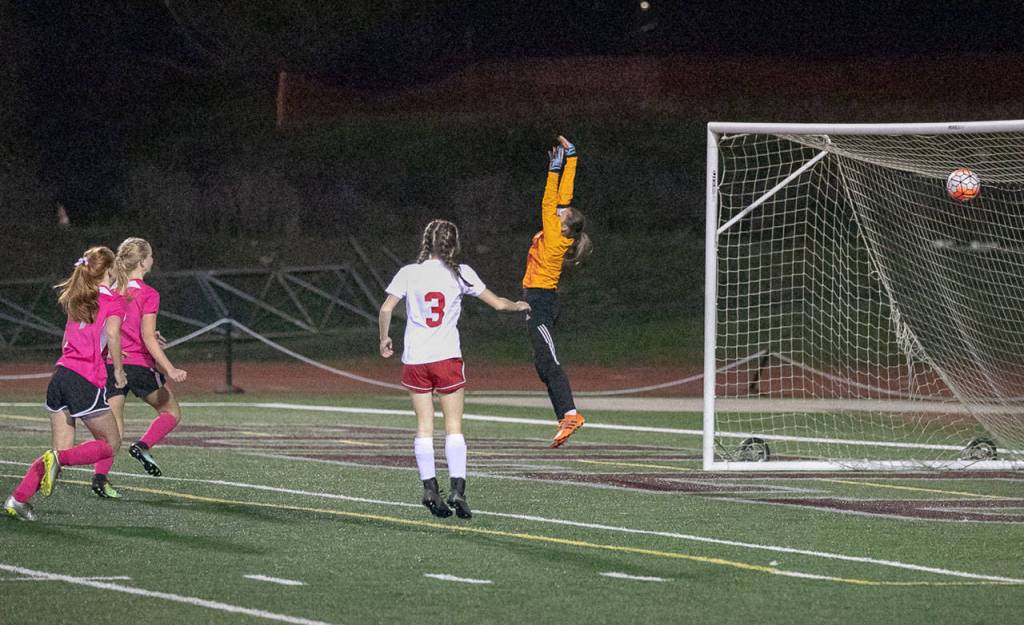 Hoquiam keeper Jade Cox, right, jumps to try to make a save on Lexi Lovells second-half goal that proved to be the game winner in a Montesanos 3-1 win on Thursday. (Photo by Shawn Donnelly)