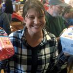 (Kat Bryant | Grays Harbor News Group) Michelle Corey, co-winner of the adult division in the cranberry eating contest, shows off her prizes, donated by Ocean Spray.