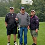 Doug King, middle, is flanked by Brian Dayton, left, and Ron Stiles after King recorded a hole-in-one on the 15th hole at Highland Golf Course on Friday. (Submitted Photo)
