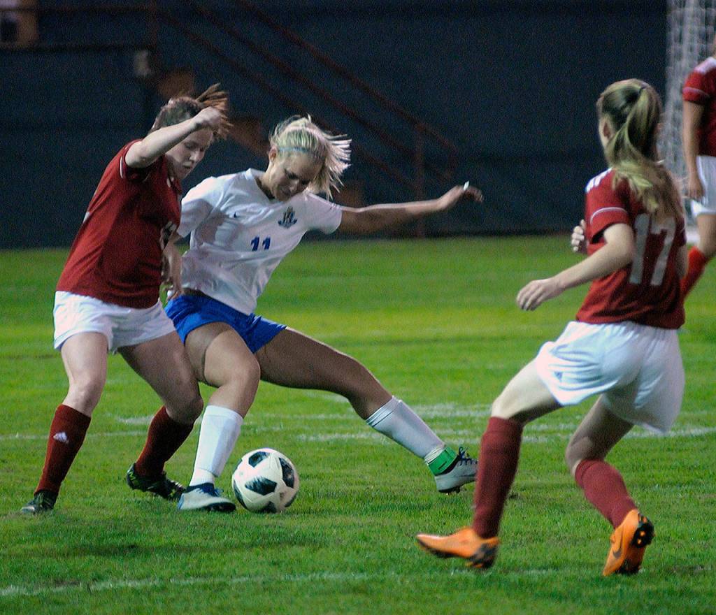 Hoquiams Taylor Strom, left, and Elmas Brooke Sutherby battle for possession in the second half of a match at Olympic Stadium. (Hasani Grayson | Grays Harbor News Group)
