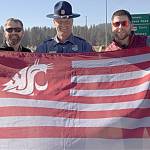 As WSU alumni Tyler Barkstrom, left, and Adam Benson stood on an overpass in Spokane waiting for the ESPN College GameDay bus to pass through on its way to Pullman, a Washington state trooper approached them. They were worried that he was going to tell them to move along  but instead, he joined them in waving the Cougar flag.