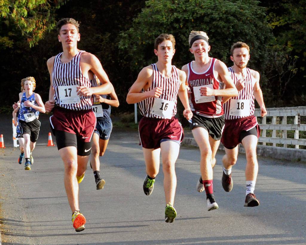 The eventual 1A Evergreen league champion, Hoquiams Adam Petersen, second from right, races along the Lake Sylvia Road surrounded by a trio of Montesano runners, including league runner-up, Martin Shuck (16) at the league championship meet on Thursday. (Ryan Sparks | Grays Harbor News Group)