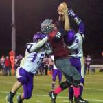 Hoquiams Payton Quintanilla rises to make a play on the ball against Sequims Taig Wiker (15) and Isaiah Cowan (61) on Friday at Olympic Stadium. (Photo by Patti Reynvaan)