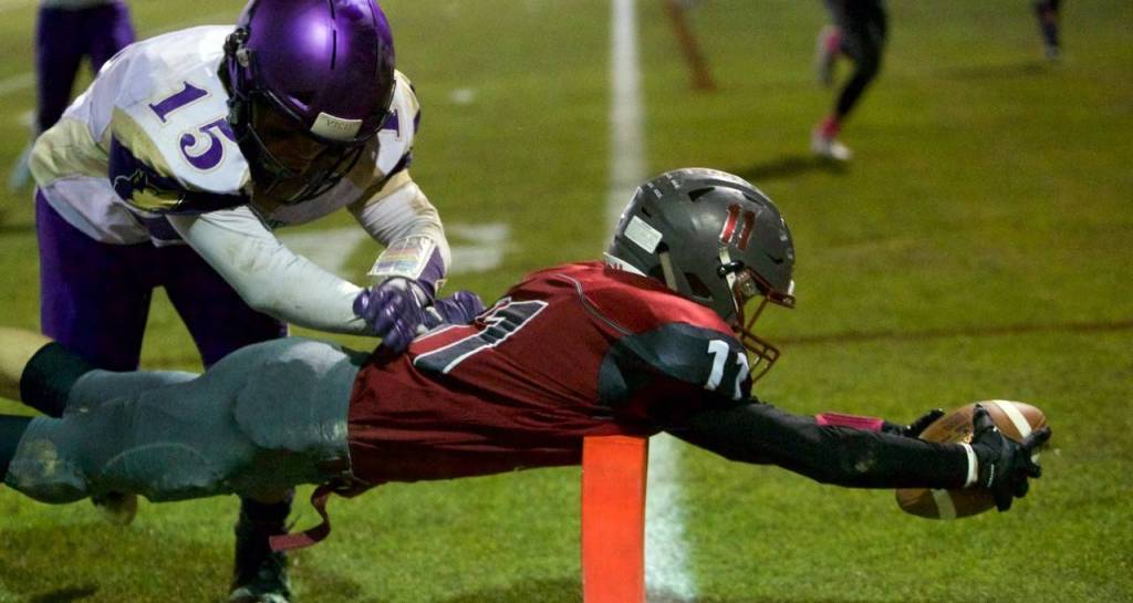 Hoquiams Cameron Bumstead dives across the goal line before Sequim safety Taig Wiker can make the tackle in the Grizzlies 42-35 win on Friday. (Photo by Patti Reynvaan)