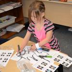 Louis Krauss | The Daily World                                A student at Robert Gray Elementary draws a line for her robot to follow.