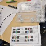 Louis Krauss | The Daily World                                A guide shows the different-colored codes students can draw to make their robots move in different ways.