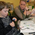 Louis Krauss | The Daily World                                A student uses markers to make a code for his robot to speed up.