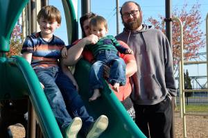 (Courtesy photo) Marley Impey is held by his mom, Chantel, flanked by his 9-year-old brother, Dominic, and his dad, Chris.