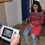 Louis Krauss | The Daily World                                Stevens Elementary student Arianna Alavez gets her eyes examined by Erv Granahan on Thursday.