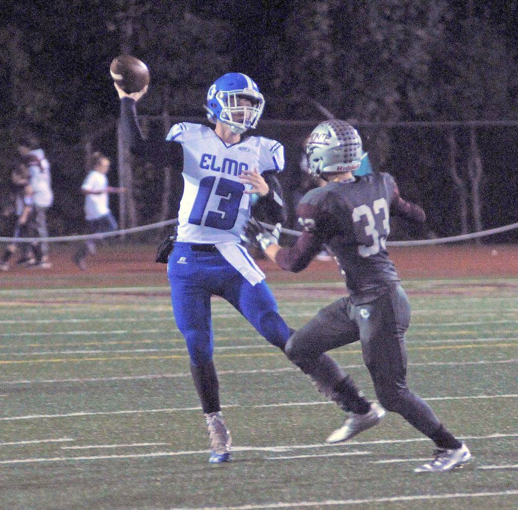 Elams Cody Vollan throws the ball down field while under pressure from Montesanos Jordan King in he second quarter at Jack Rotltle Field on Friday night. (Hasani Grayson | Grays Harbor News Group)