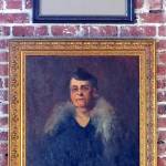 (Photo by Mitchell Chapman) From the top, portraits painted by Elizabeth Curtis, Vicente Seritti, Alice Hulich Preston Lavallee and U.C. Tenney. All purchased on eBay; hung on a narrow strip of brick wall.