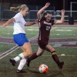 Elmas Molly Johnston, left, gets past Montesano Lexi Lovell in the second half of a match on Thursday. (Hasani Grayson | Grays Harbor News Group)