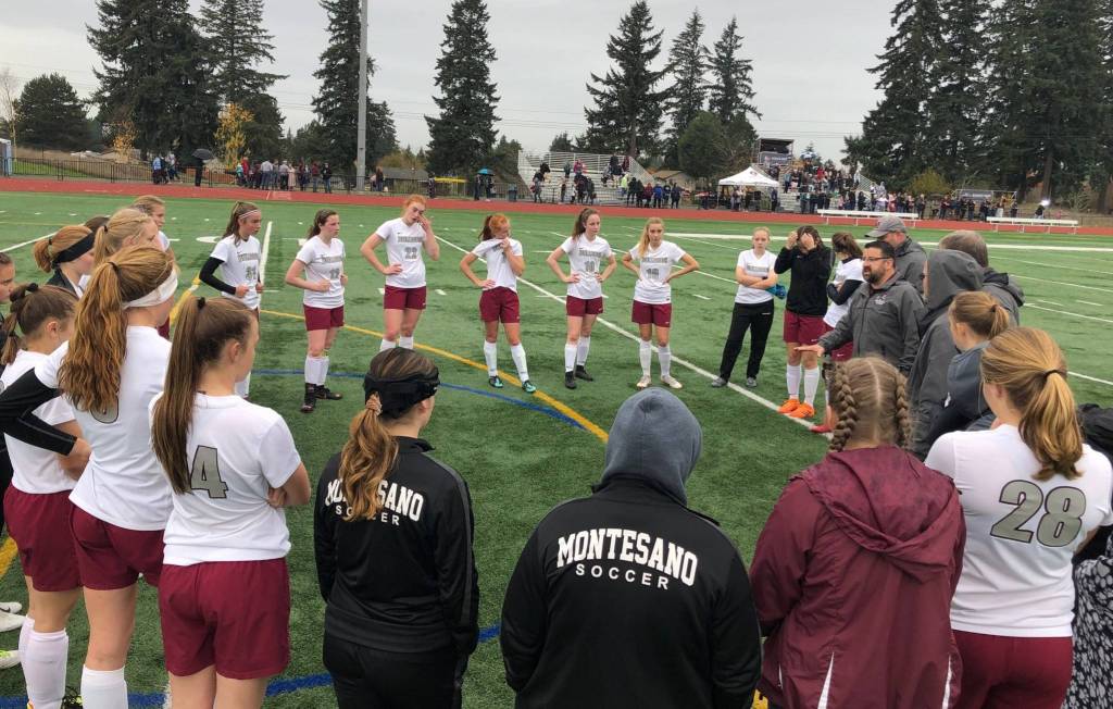Montesano head coach Fidel Sanchez, right, speaks to his team after a heart-breaking 2-0 loss to Kings Way Christian in the 1A District IV title game in Vancouver. (Andy Buhler | The Columbian)