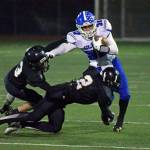 Elmas Taitum Brumfield is tackled by Meridians Cameron Webster (2) during Saturdays first-round state playoff game in Bellingham. (Eric Trent | Lynden Tribune)