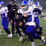 Elma quarterback Cody Vollan carries the footbal in the Eagles 40-21 loss against Meridian on Saturday. Vollan ran for a team-high 104 yards in the game (Eric Trent | Lynden Tribune)