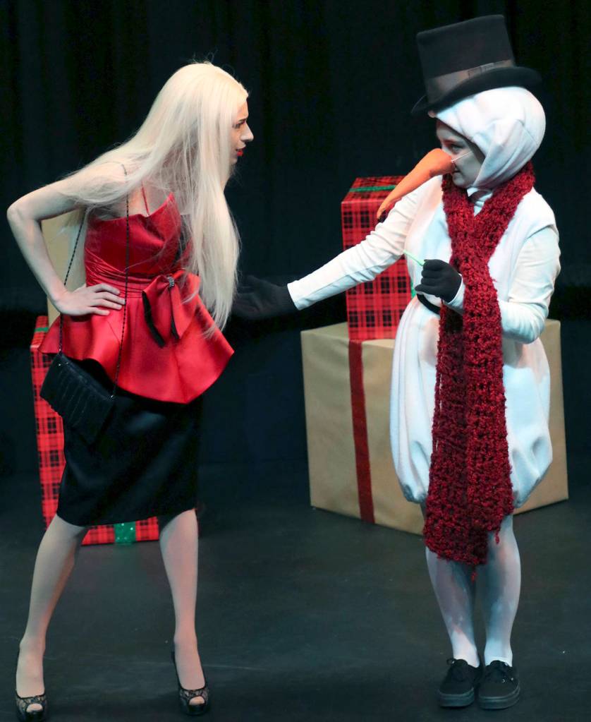 (Keith Krueger) A display model (Sadie Karl) is hesitant to hold hands with an overly enthusiastic snowman (Susanna Watkins).
