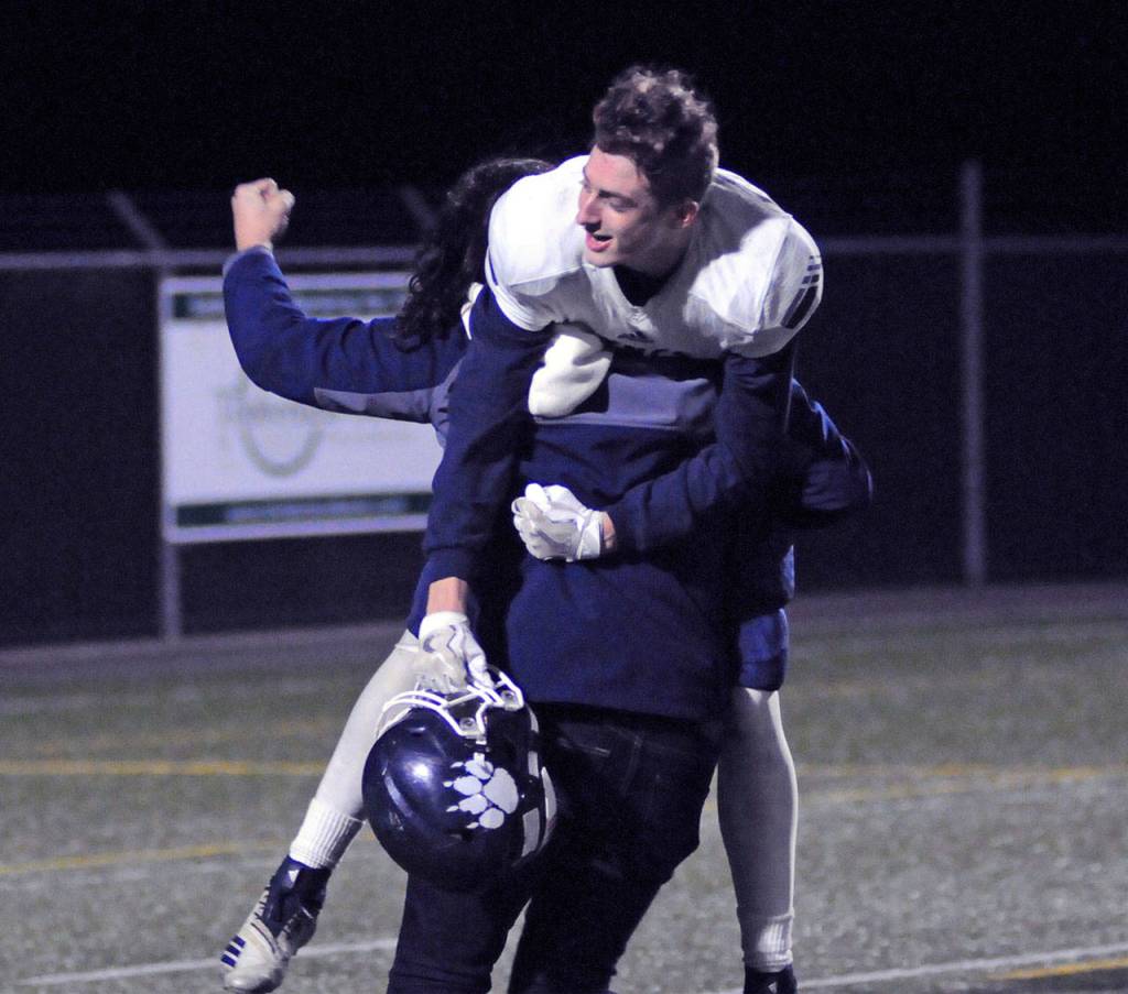 Lynden Christians Jalen Apol is carried by a friend after the Lyncs defeated Hoquiam 45-6 on Saturday to advance to the 1A State Football Semifinals. (Ryan Sparks | Grays Harbor News Group)
