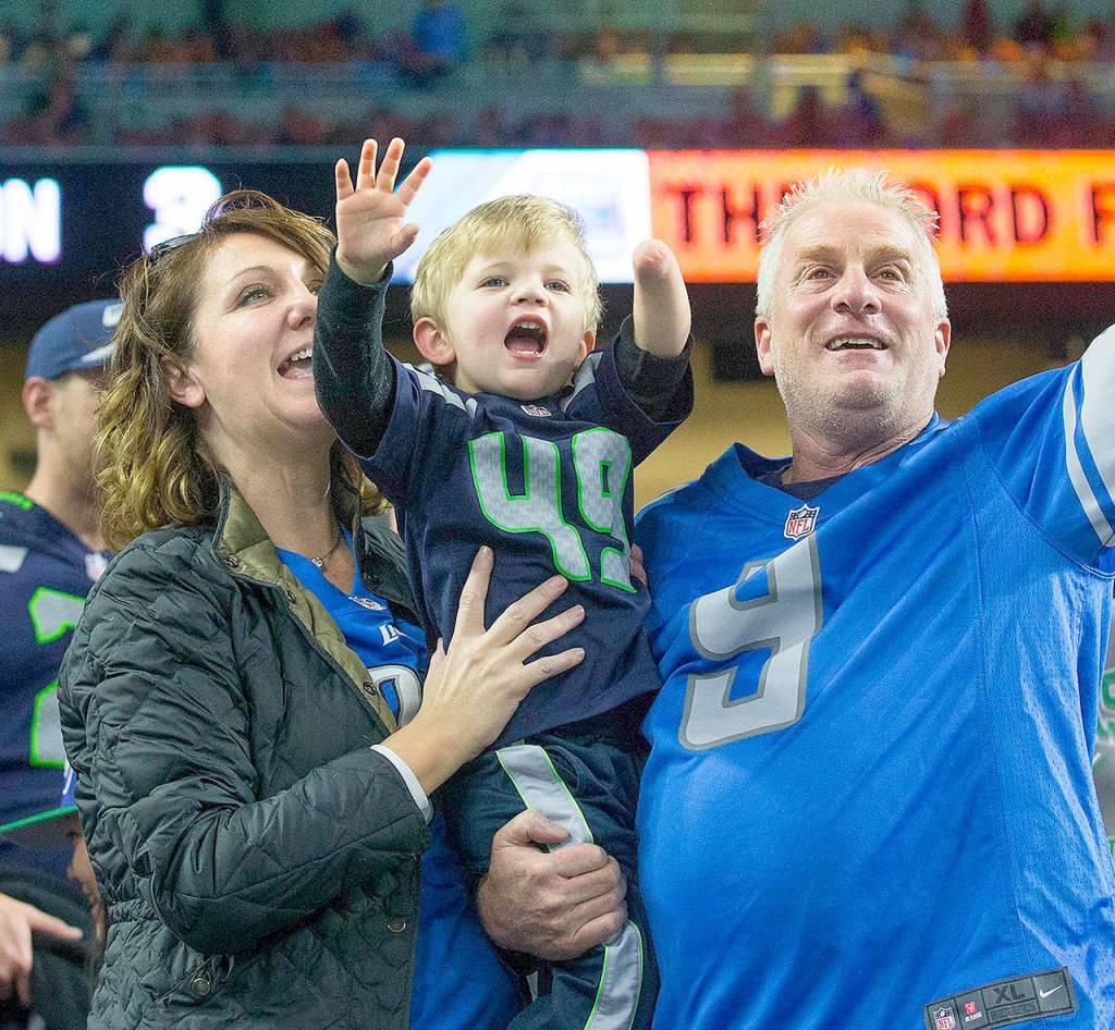 Blake Venier, 3, center, yells out toward Seattle Seahawks linebacker Shaquem Griffin while watching the Seahawks play the Detroit Lions at Ford Field in Detroit on October 28, 2018. With Blake are his grandmother Deb Holland, left, and Joe Addison. (Mike Siegel/Seattle Times)