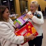 Patrick Raycraft | Hartford Courant                                 Karen Cote, right, welcomes Donna Bordonaros donation of food items to Hero Boxes.
