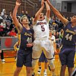 Hoquiams Kyle Larson (5) is defended by Onalaskas David Fritch (44) and Kayden Allison (40) during Hoquiams win on Wednesday. (Ryan Sparks | Grays Harbor News Group)