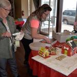 (Louis Krauss | The Daily World) Aberdeen Parks Director Stacie Barnum, right, and her mom Cheryl Konn lay out their gingerbread town.