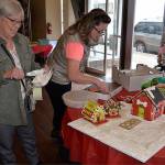 (Louis Krauss | The Daily World) Aberdeen Parks Director Stacie Barnum, right, and her mom Cheryl Konn lay out their gingerbread town.