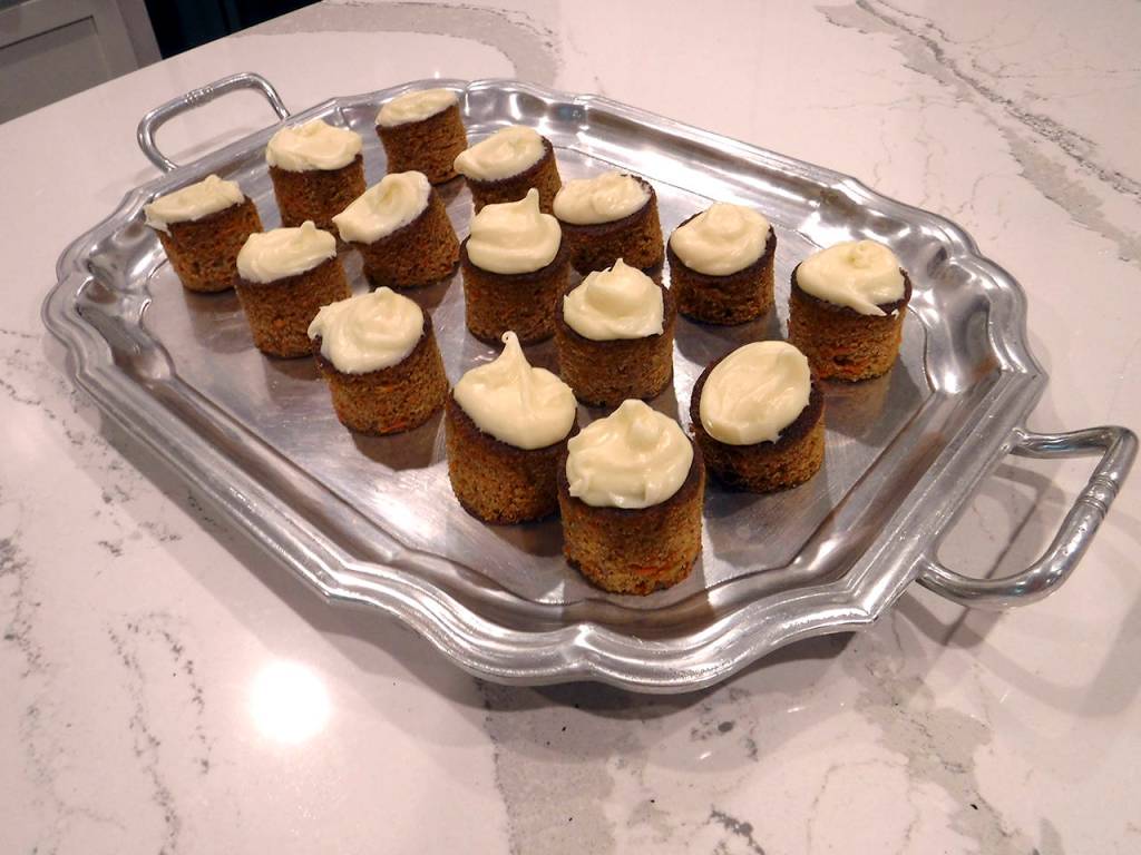 (Mitchell Chapman) Mini carrot cakes served on a large silver tray.