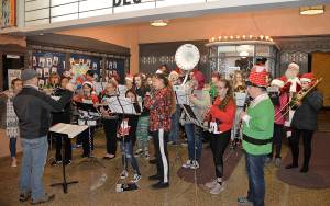 DAN HAMMOCK | GRAYS HARBOR NEWS GROUP                                Hoquiams holiday ensemble, with members of the high and middle school bands, performs a selection of holiday favorites under the marquee at the 7th Street Theatre as part of the annual Hoquiam Business Association Ho Ho Hoquiam celebration Saturday.