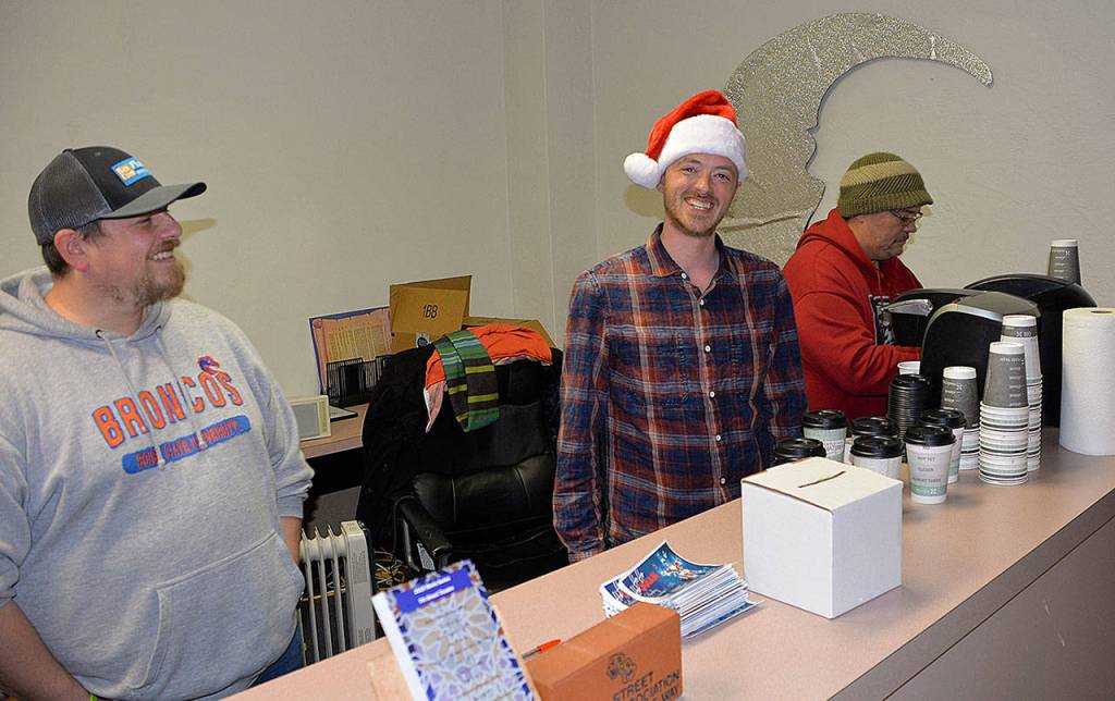 DAN HAMMOCK | GRAYS HARBOR NEWS GROUP                                From left, Jeff Izatt from ResCom Flooring, Kyle Pauley of the Hoquiam Business Association, and volunteer Larry Burgher hand out free hot cocoa for the Cocoa Stroll and ballots for the Festival of Trees during Saturdays Ho Ho Hoquiam celebration.
